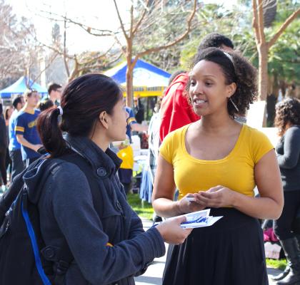 Students talking at campus event.